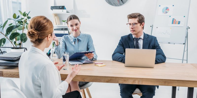 back-view-of-employee-talking-with-recruiters-on-job-interview-in-office